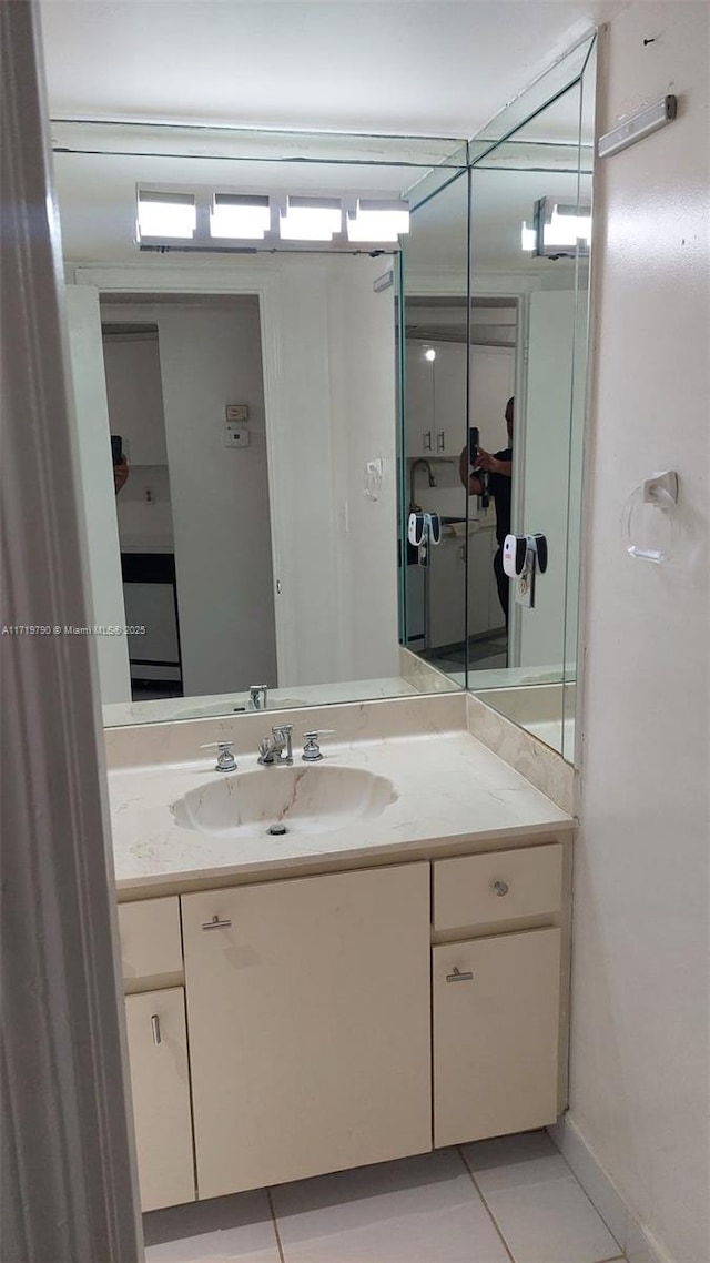 bathroom with tile patterned floors and vanity