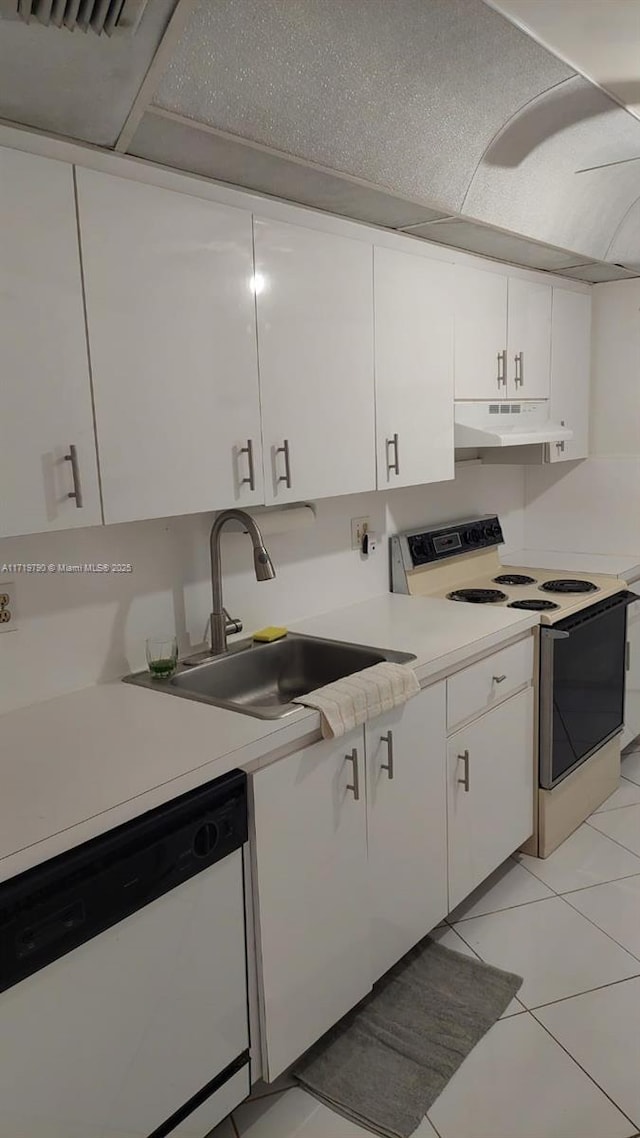 kitchen featuring sink, white cabinets, light tile patterned flooring, and white appliances