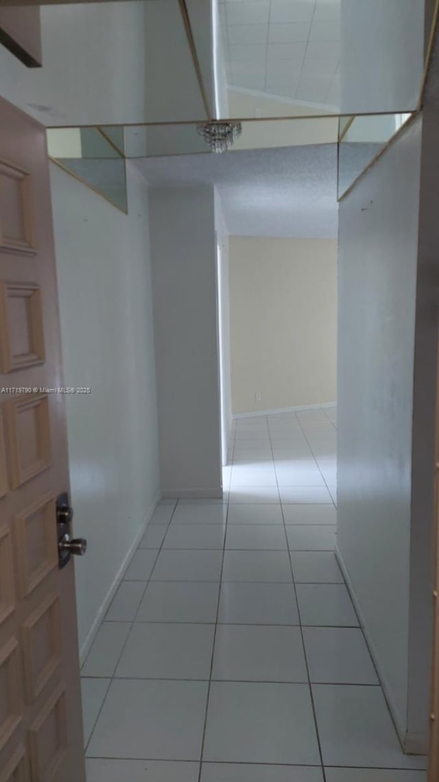 hall featuring light tile patterned floors