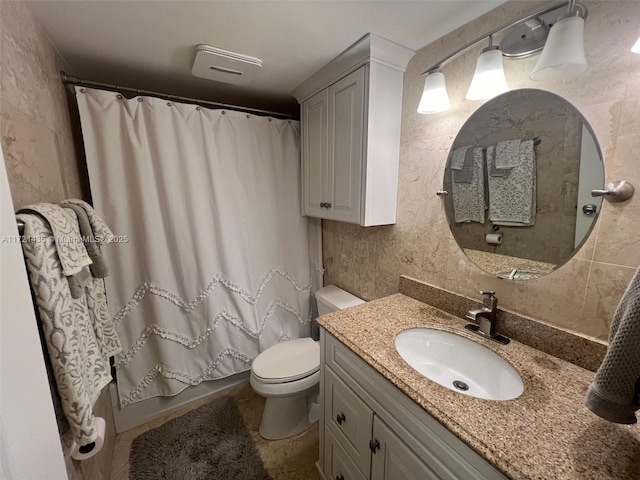 full bathroom featuring vanity, shower / bath combination with curtain, and toilet