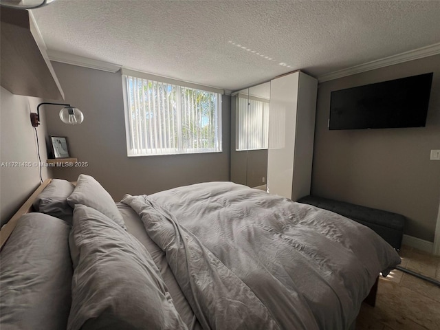 bedroom featuring a textured ceiling and crown molding