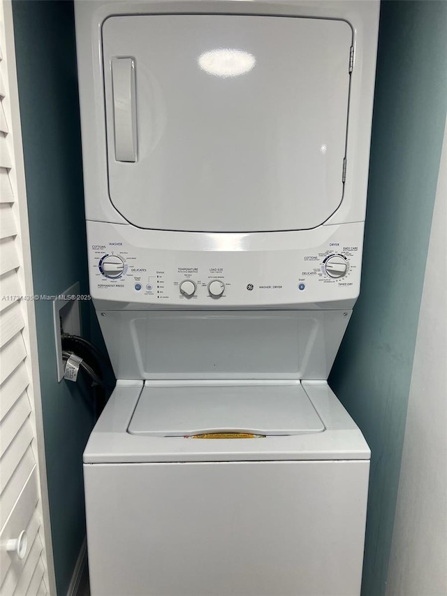 washroom featuring stacked washer / dryer