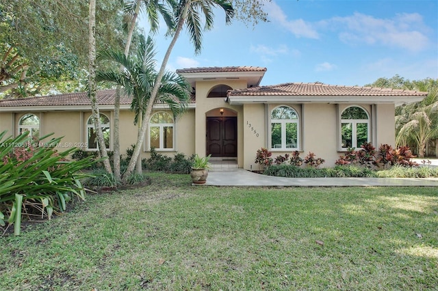 mediterranean / spanish-style home with a front yard