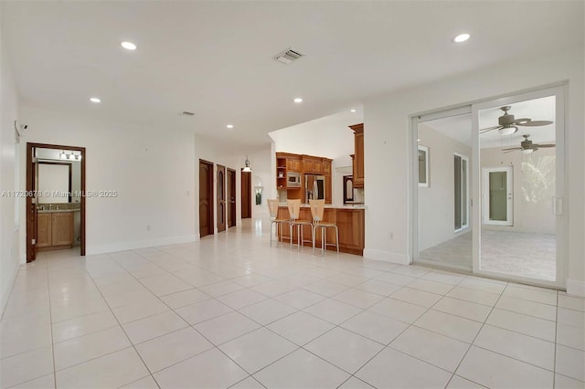 unfurnished room with light tile patterned floors and ceiling fan