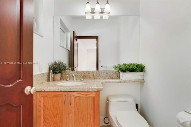 bathroom with vanity and toilet