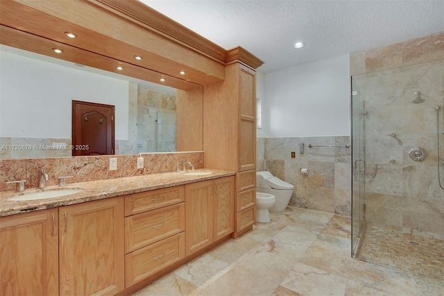 bathroom with an enclosed shower, a textured ceiling, a bidet, tile walls, and toilet