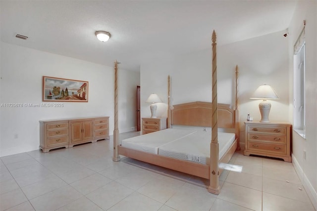 tiled bedroom featuring a textured ceiling