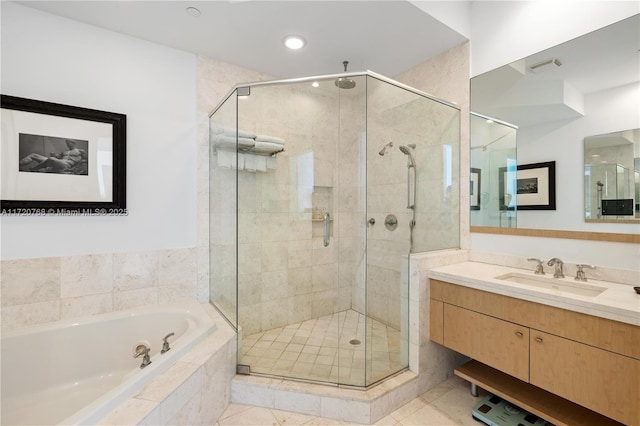 bathroom featuring tile patterned floors, separate shower and tub, and vanity