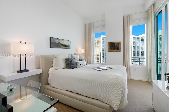 bedroom with light carpet and multiple windows