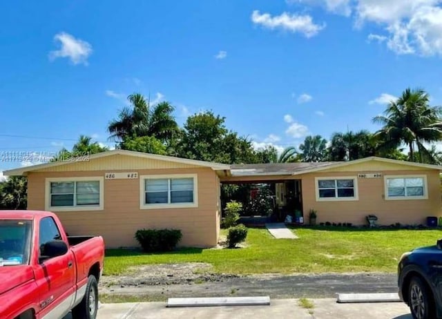 single story home with a carport and a front yard