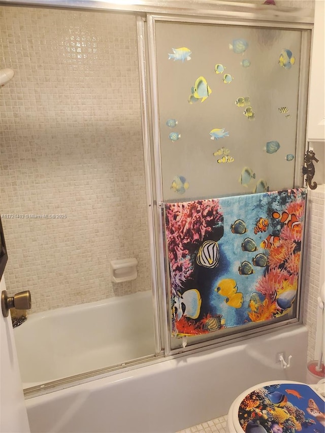 bathroom with toilet, tile patterned floors, and enclosed tub / shower combo