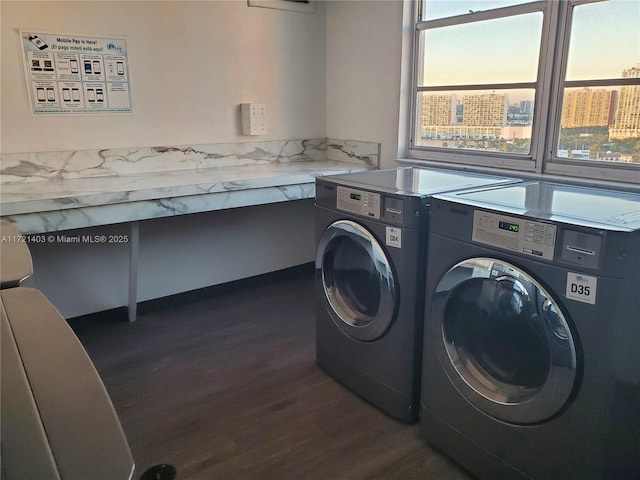 washroom featuring dark hardwood / wood-style floors, a healthy amount of sunlight, and separate washer and dryer