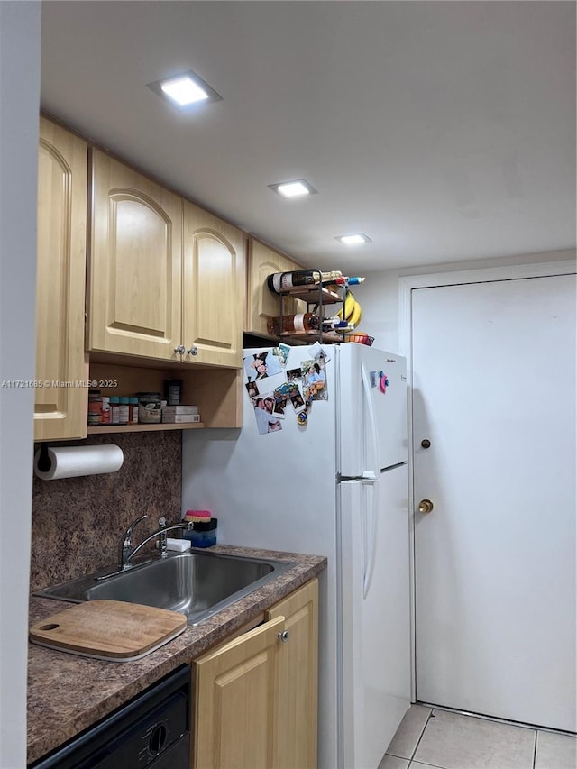 kitchen with decorative backsplash, sink, light tile patterned floors, light brown cabinets, and black dishwasher