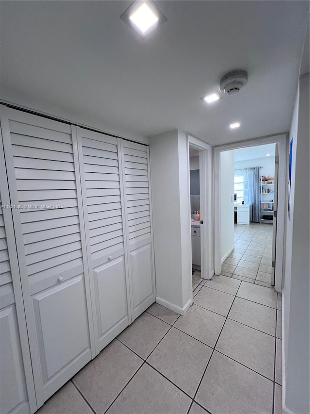 corridor with light tile patterned floors