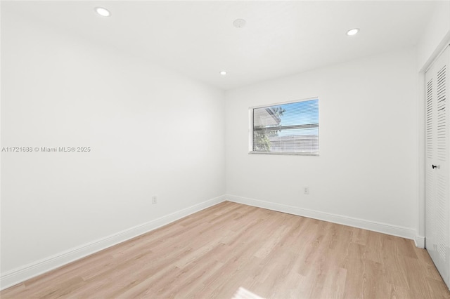 unfurnished bedroom featuring a closet and light hardwood / wood-style flooring