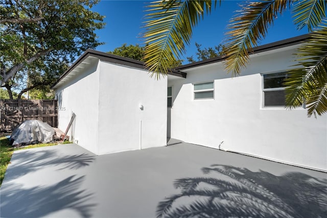 view of side of property featuring a patio area