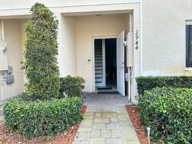 entrance to property featuring stucco siding