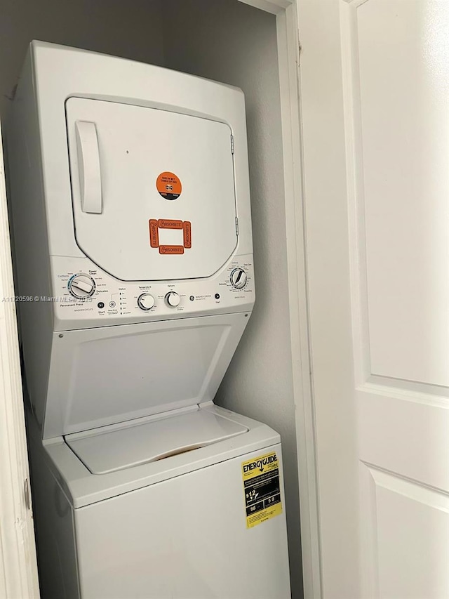 washroom with laundry area and stacked washing maching and dryer