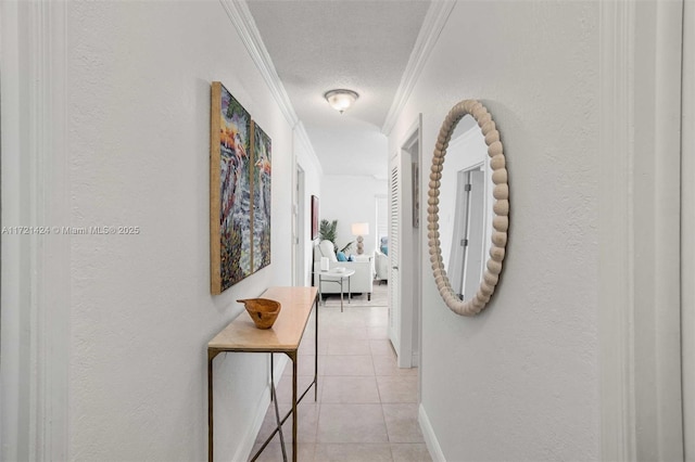 hallway featuring light tile patterned floors, a textured ceiling, and crown molding