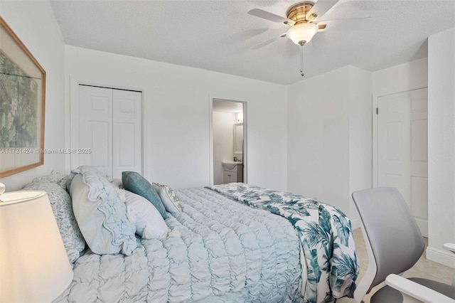 bedroom with ensuite bath, ceiling fan, a closet, and a textured ceiling