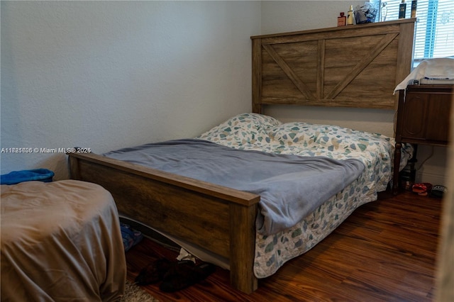 bedroom featuring dark hardwood / wood-style flooring