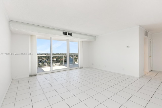 tiled spare room with crown molding and floor to ceiling windows