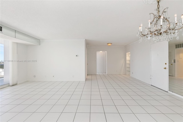 tiled empty room with ornamental molding and an inviting chandelier