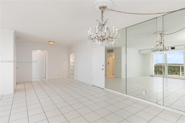 tiled spare room with crown molding and a notable chandelier