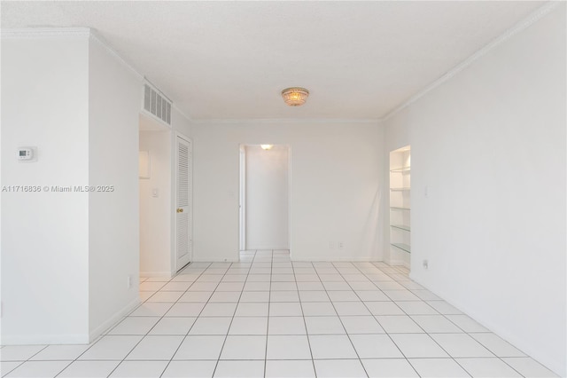 tiled spare room with ornamental molding