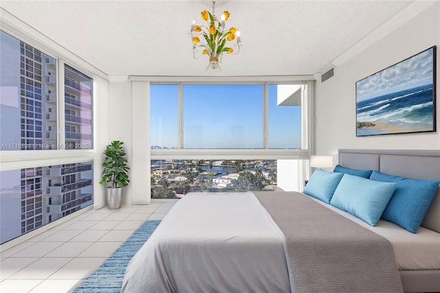 bedroom featuring floor to ceiling windows, crown molding, light tile patterned flooring, and a textured ceiling