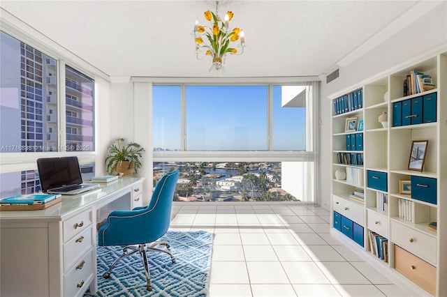 home office with light tile patterned floors, a textured ceiling, and a wall of windows