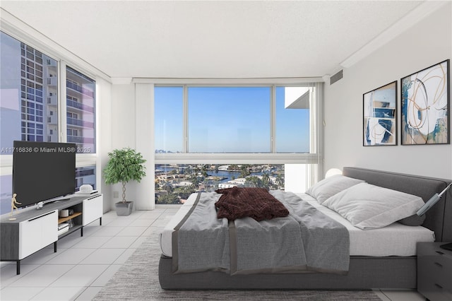 tiled bedroom featuring floor to ceiling windows and a textured ceiling