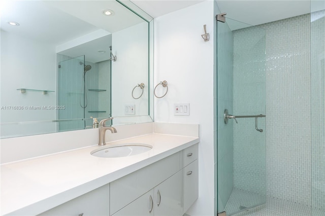 bathroom with vanity and a shower with shower door