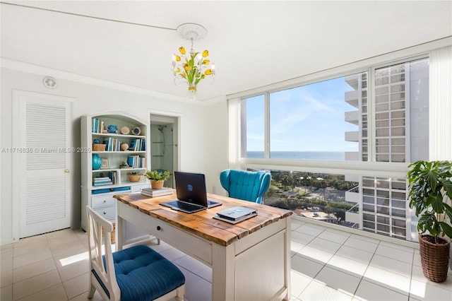 tiled office space featuring ornamental molding and a water view