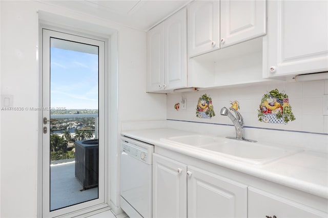 kitchen featuring tasteful backsplash, dishwasher, sink, and white cabinets