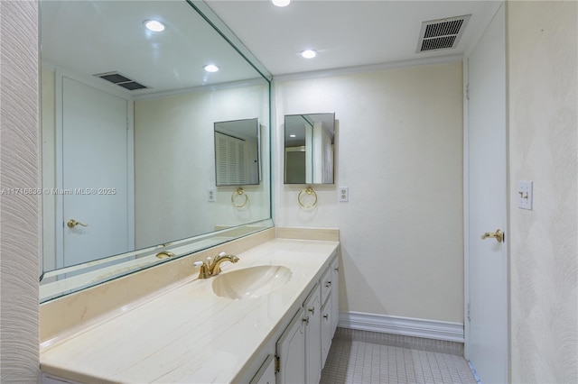 bathroom with ornamental molding, vanity, and tile patterned flooring