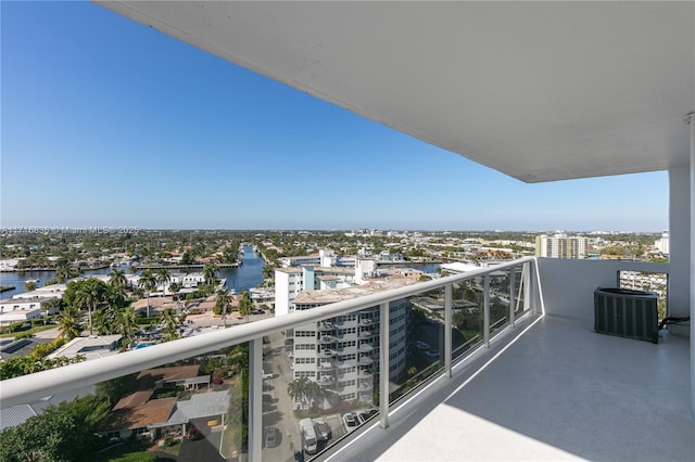 balcony featuring a water view and central air condition unit