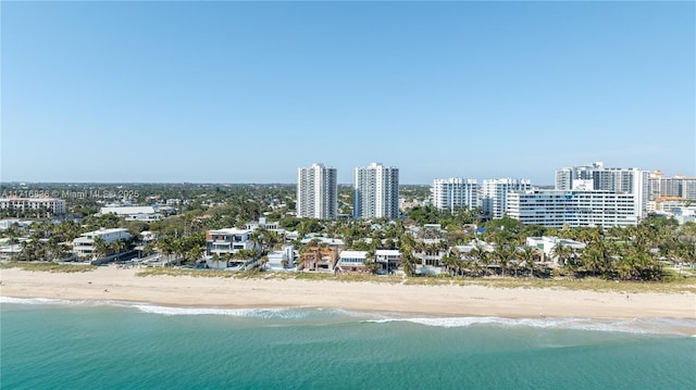 birds eye view of property featuring a view of the beach and a water view