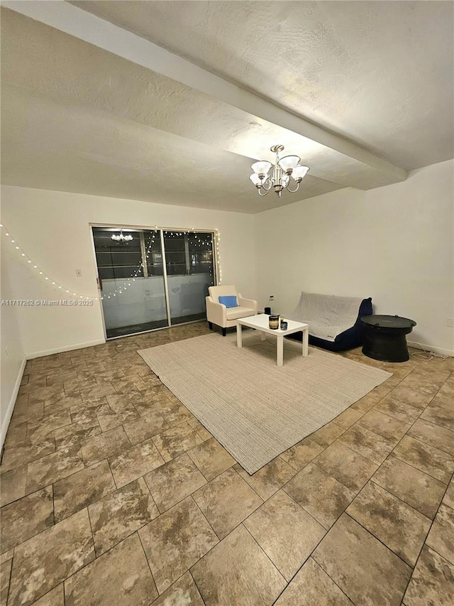 unfurnished room with a textured ceiling and a notable chandelier