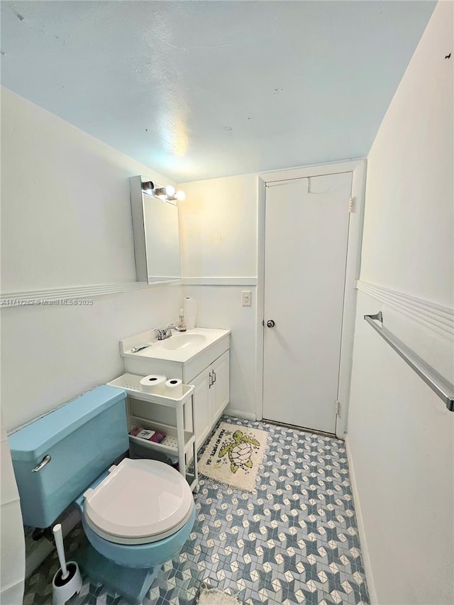 bathroom featuring vanity and toilet