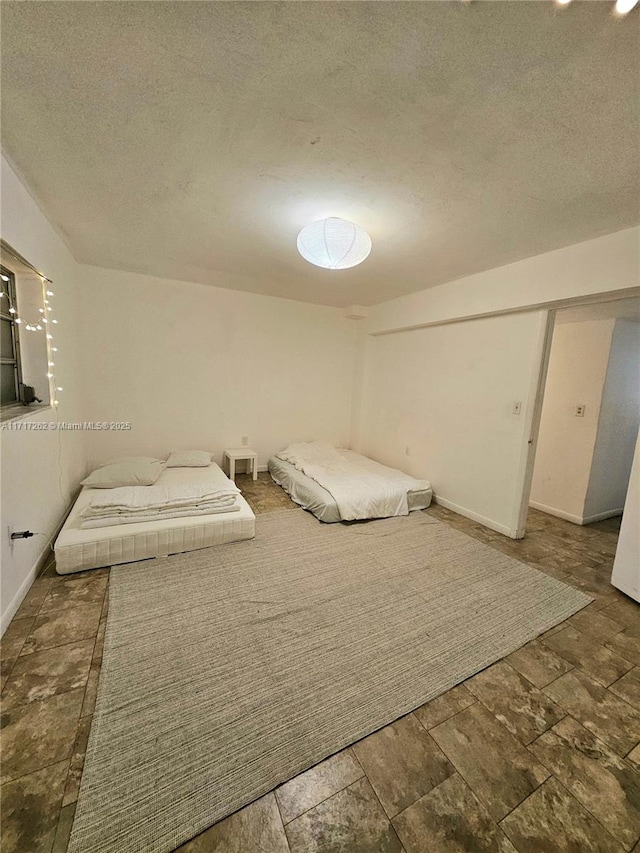 unfurnished bedroom featuring a closet and a textured ceiling