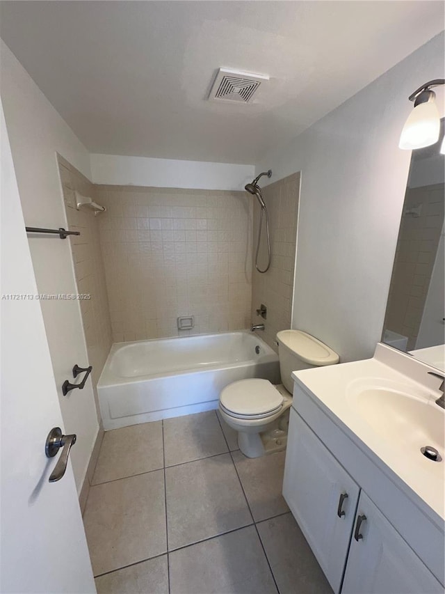 full bathroom with tile patterned floors, vanity, toilet, and tiled shower / bath combo