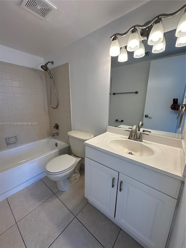 full bathroom featuring tile patterned floors, tiled shower / bath combo, toilet, and vanity