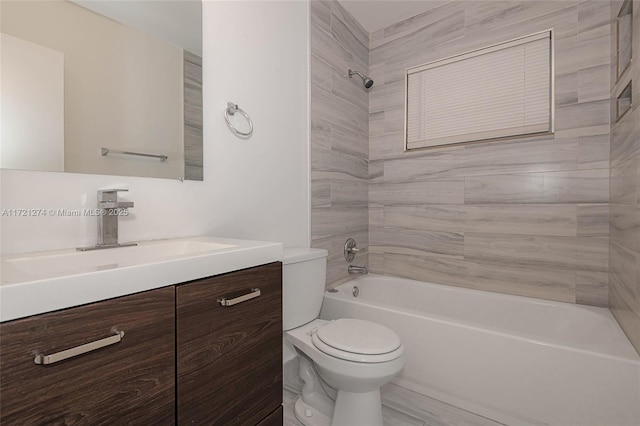 full bathroom with vanity, tiled shower / bath, and toilet