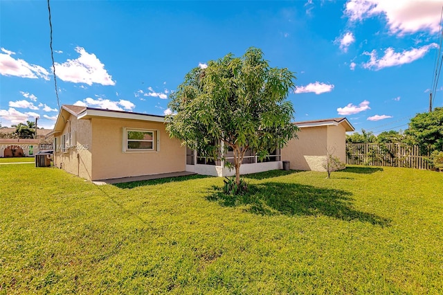 rear view of property with a yard and cooling unit