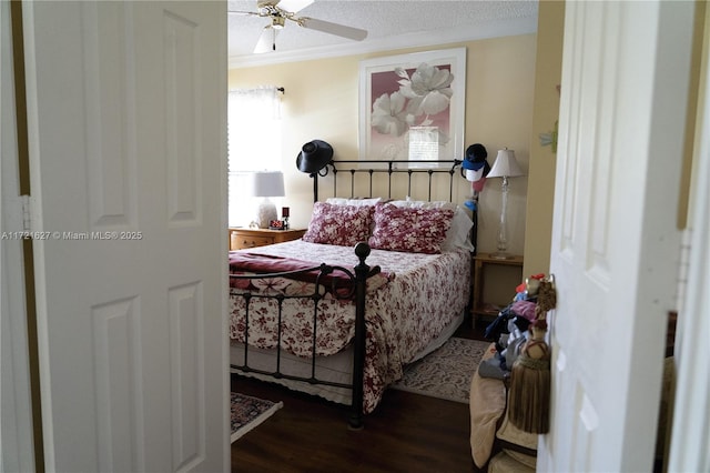 bedroom featuring a textured ceiling, ceiling fan, crown molding, and dark hardwood / wood-style floors