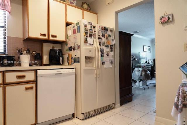 kitchen featuring white cabinets, a textured ceiling, white appliances, light tile patterned flooring, and tasteful backsplash