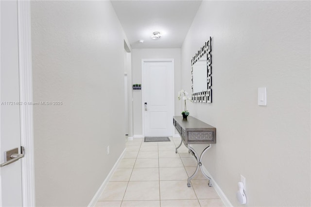 hall with light tile patterned floors