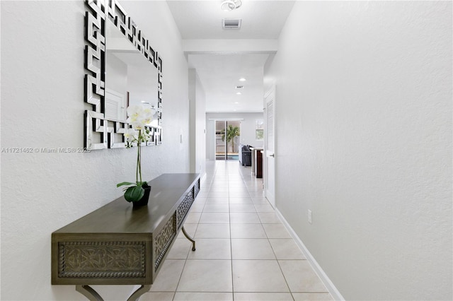 corridor featuring light tile patterned floors