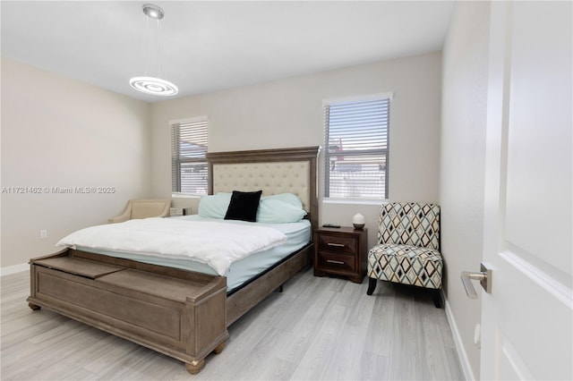 bedroom featuring multiple windows and light wood-type flooring